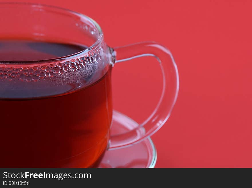 Cup of tea on red background