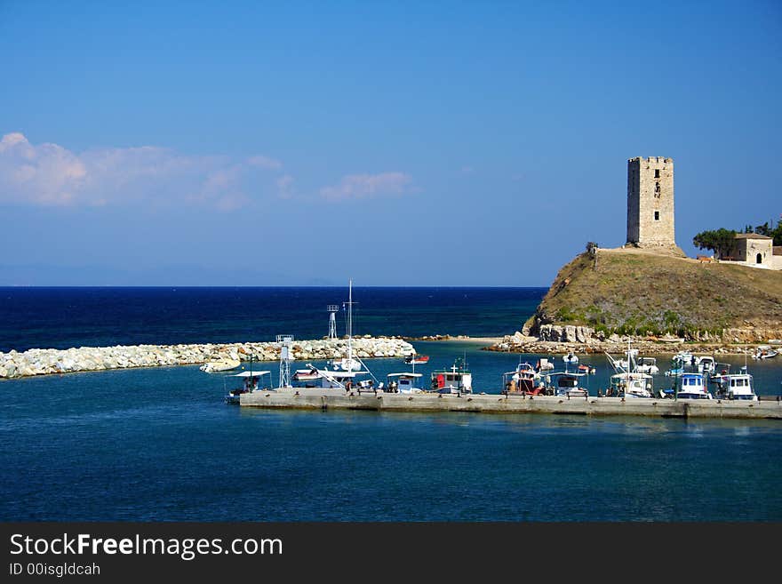 Colorful boats and an ancient tower in Greece. Colorful boats and an ancient tower in Greece