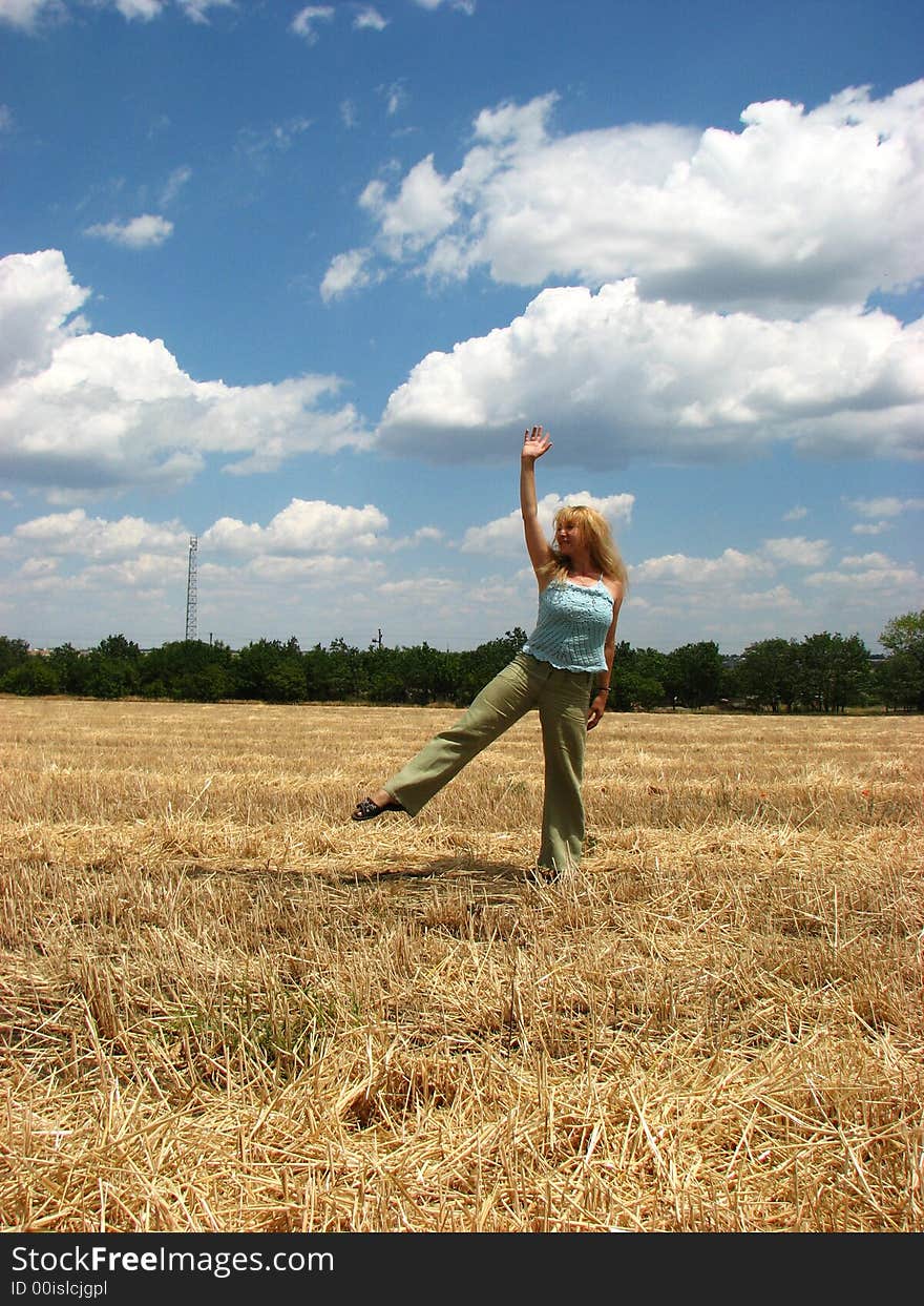 Young woman in yellow field do handsprings. Young woman in yellow field do handsprings