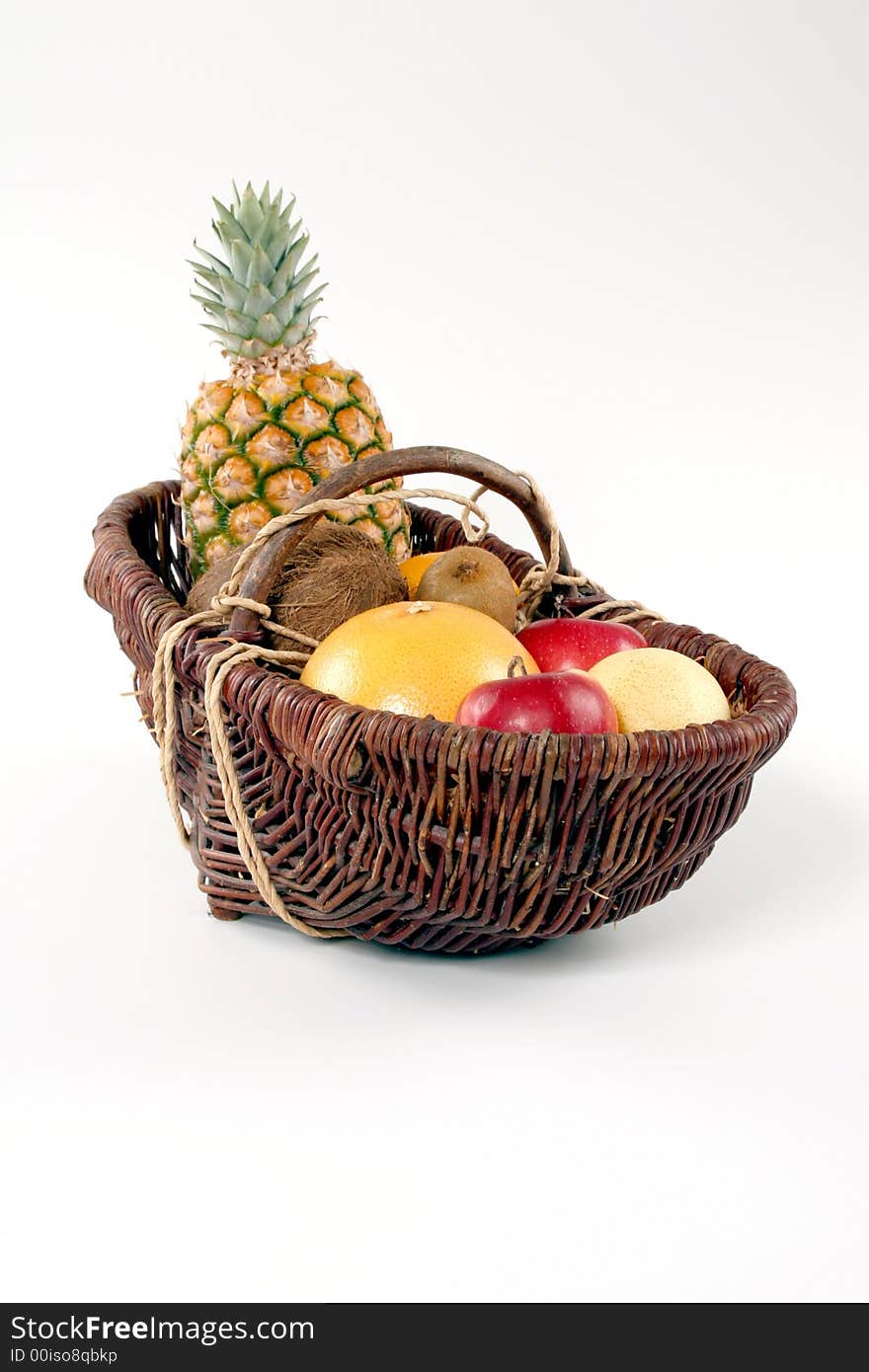 Basket of tropical fruit on a white background