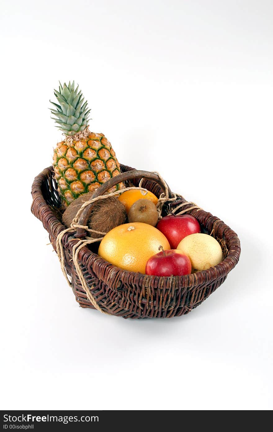 Basket of tropical fruit on a white background