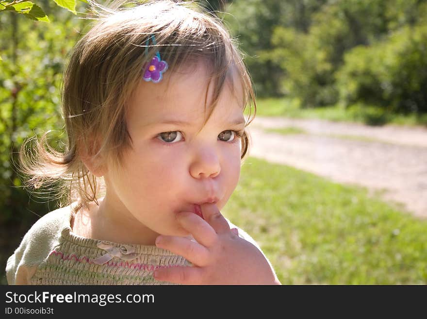 A little with her finger in her mouth. A little with her finger in her mouth