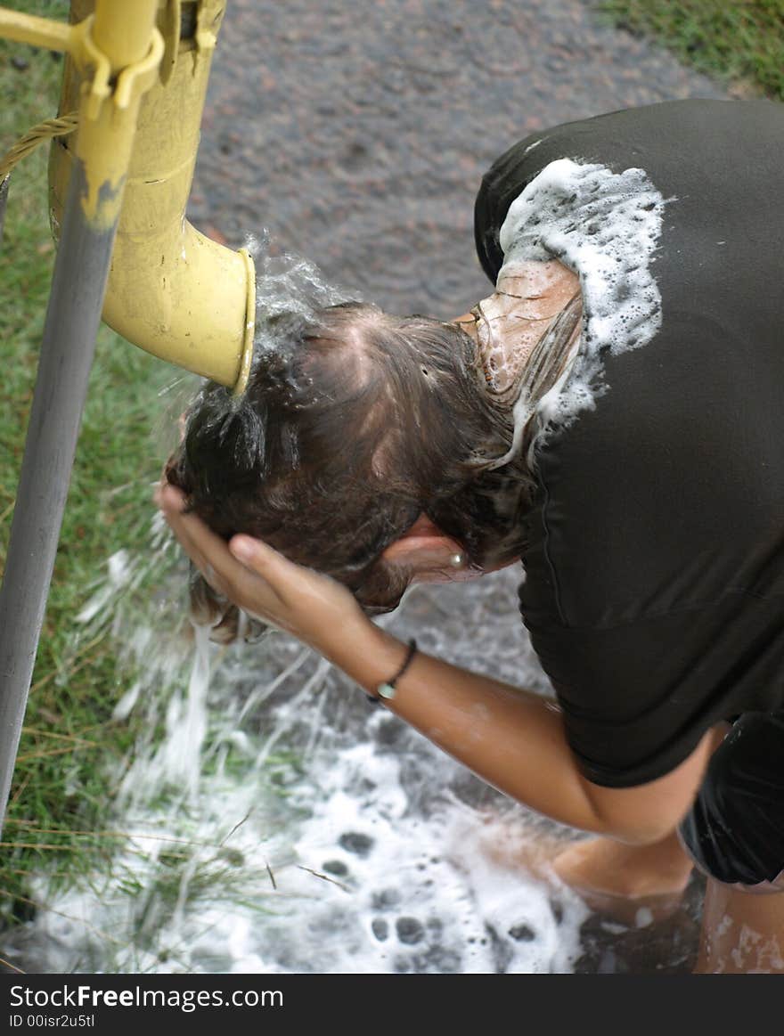 Washing her hair in the rain