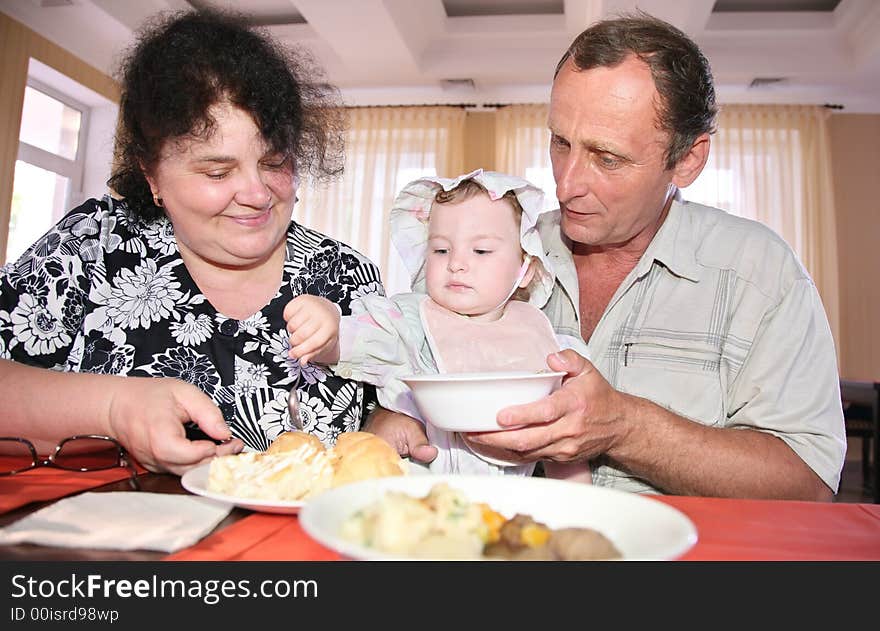 Grandmother with grandfather nourish child. Grandmother with grandfather nourish child