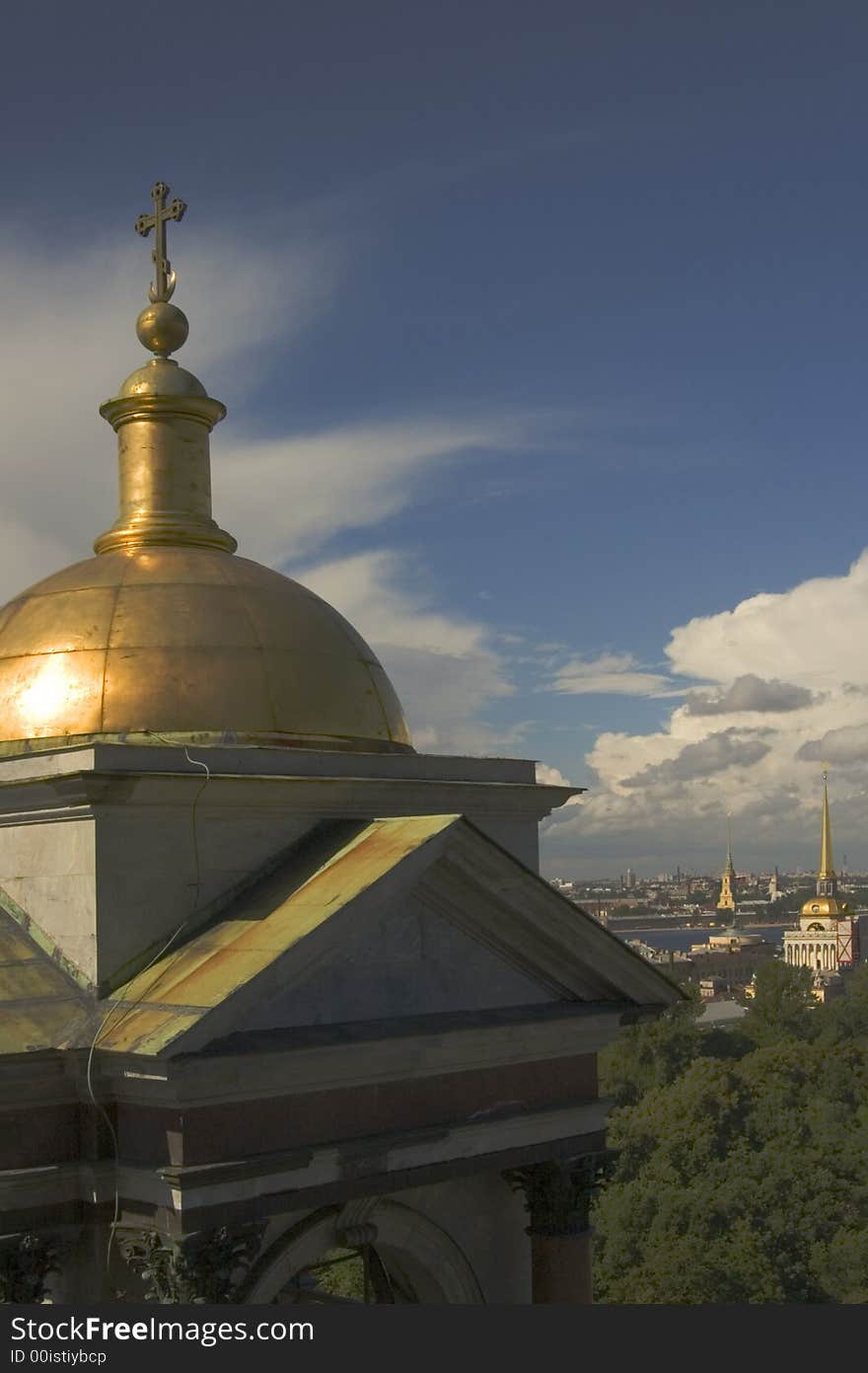 Cold dome of a temple and while clouds