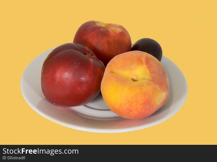 Fresh peach,nectarine and plum on the plate-isolated. Fresh peach,nectarine and plum on the plate-isolated.