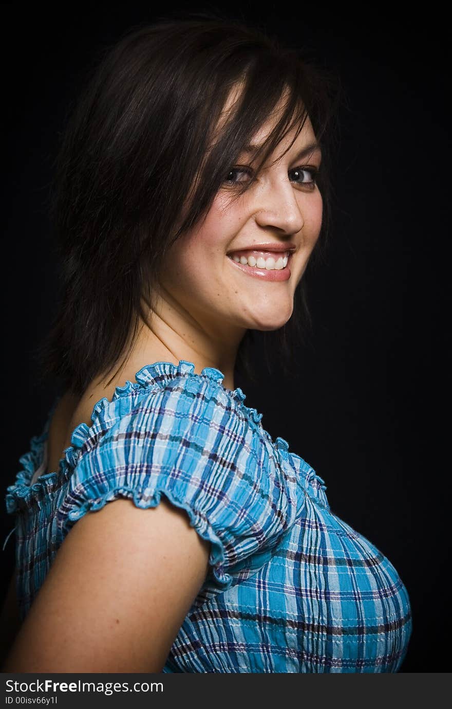 Beautiful young woman against a black background