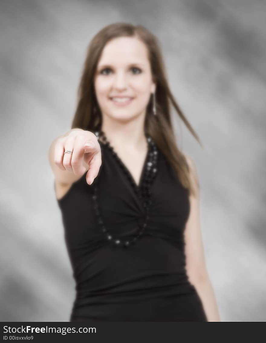 Beautiful young woman pointing at the camera