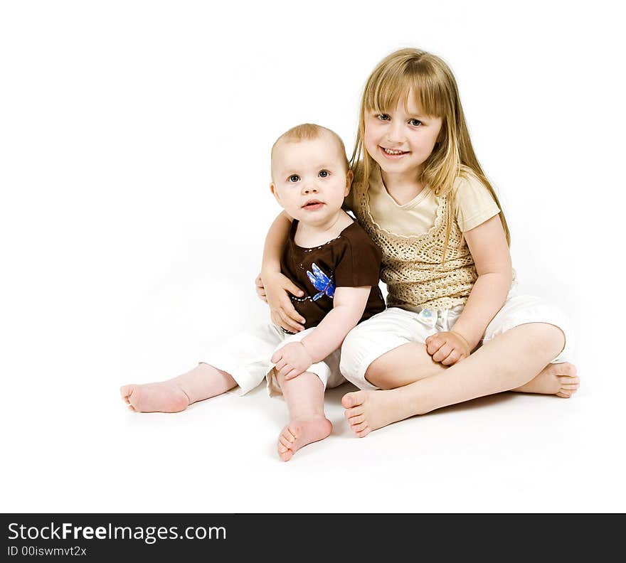 Big sister giving her little sister a hug. Big sister giving her little sister a hug