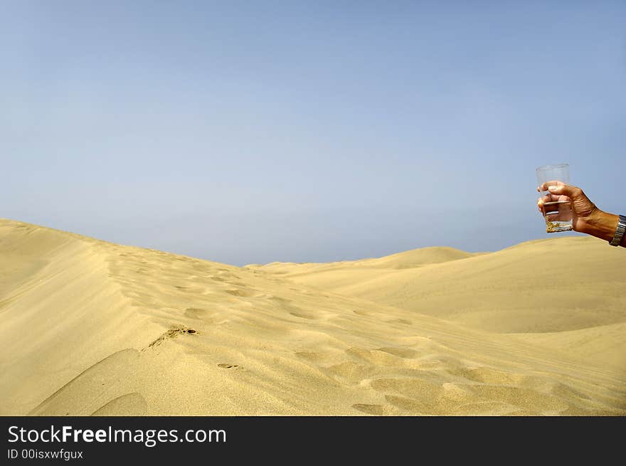 Hand and water in desert