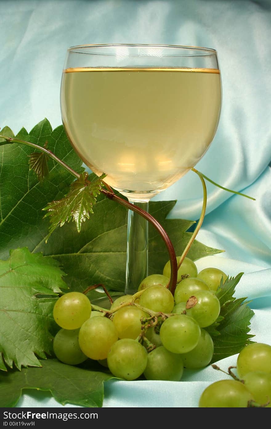 Glass white wine on blue background