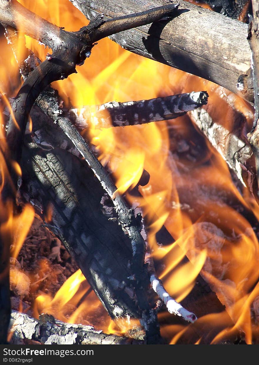 A orange fire with embers and ash. A orange fire with embers and ash.