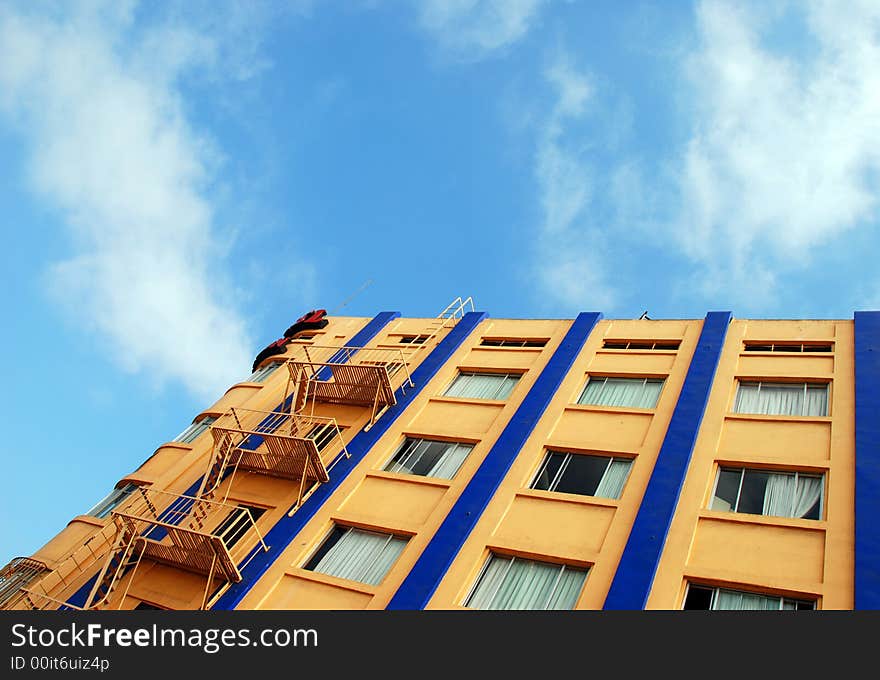 High-rise apartment building against a stark blue sky- pretty contrast. High-rise apartment building against a stark blue sky- pretty contrast