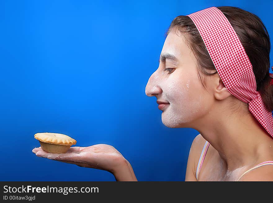 The girl and a pie on a dark blue background. The girl and a pie on a dark blue background