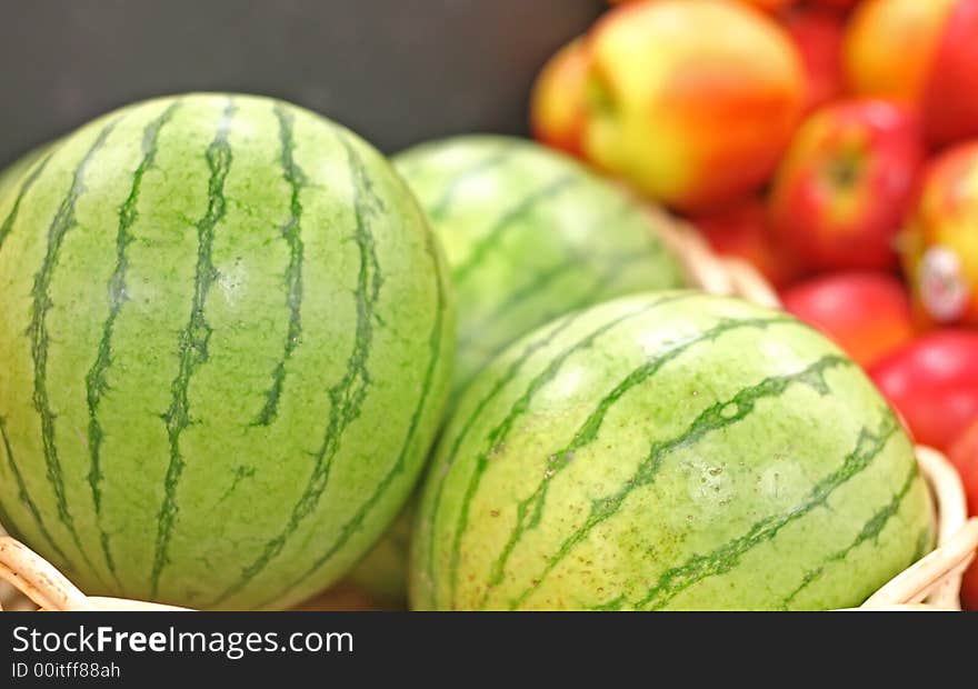 Fresh ripe watermelons and apples at a fruit stand. Fresh ripe watermelons and apples at a fruit stand