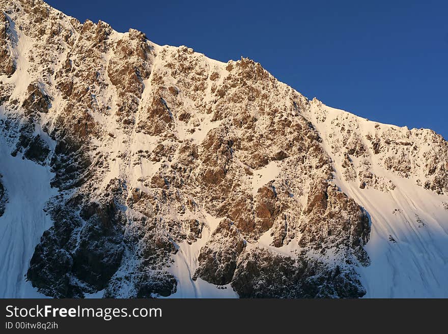 Snowy mountainside in a morning light. Snowy mountainside in a morning light