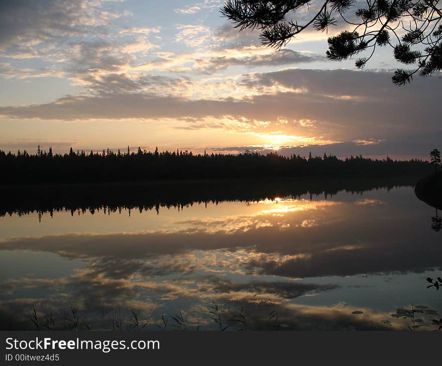 Dawn in a pine wood with a kind on one of lakes of Kareliya. Dawn in a pine wood with a kind on one of lakes of Kareliya.