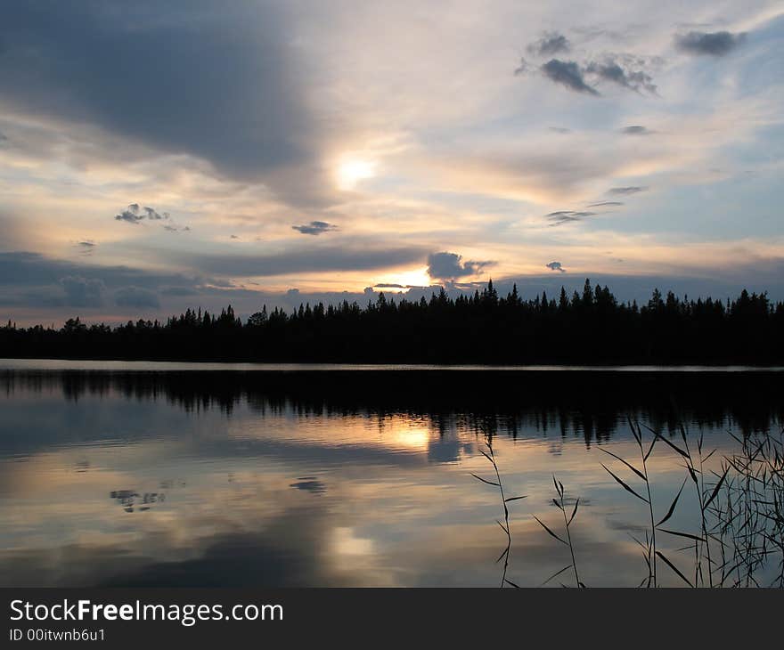 The photo was done on lakes of Kareliya in the early morning. The sun rose through dense clouds is has given photos a steel shade. The photo was done on lakes of Kareliya in the early morning. The sun rose through dense clouds is has given photos a steel shade.