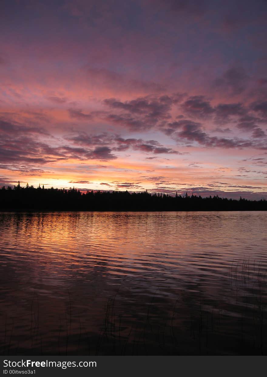 The dawn of unusual pink color photographed on lake near island Olan in the Kareliya. The dawn of unusual pink color photographed on lake near island Olan in the Kareliya.