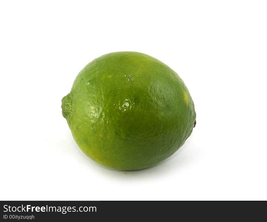 One green lime liyng on the white background. One green lime liyng on the white background