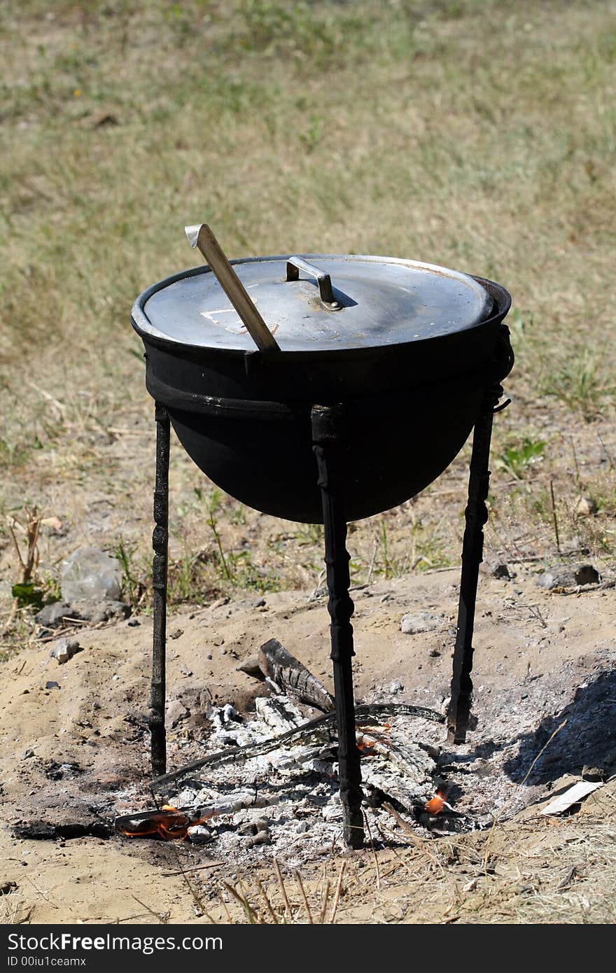 Preparation of a dinner in the big saucepan on a fire. Preparation of a dinner in the big saucepan on a fire