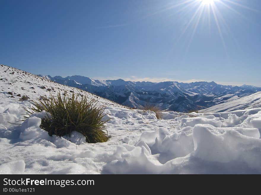 Sunflare over winter landscape at Ben Lomand saddle in NZ. Sunflare over winter landscape at Ben Lomand saddle in NZ