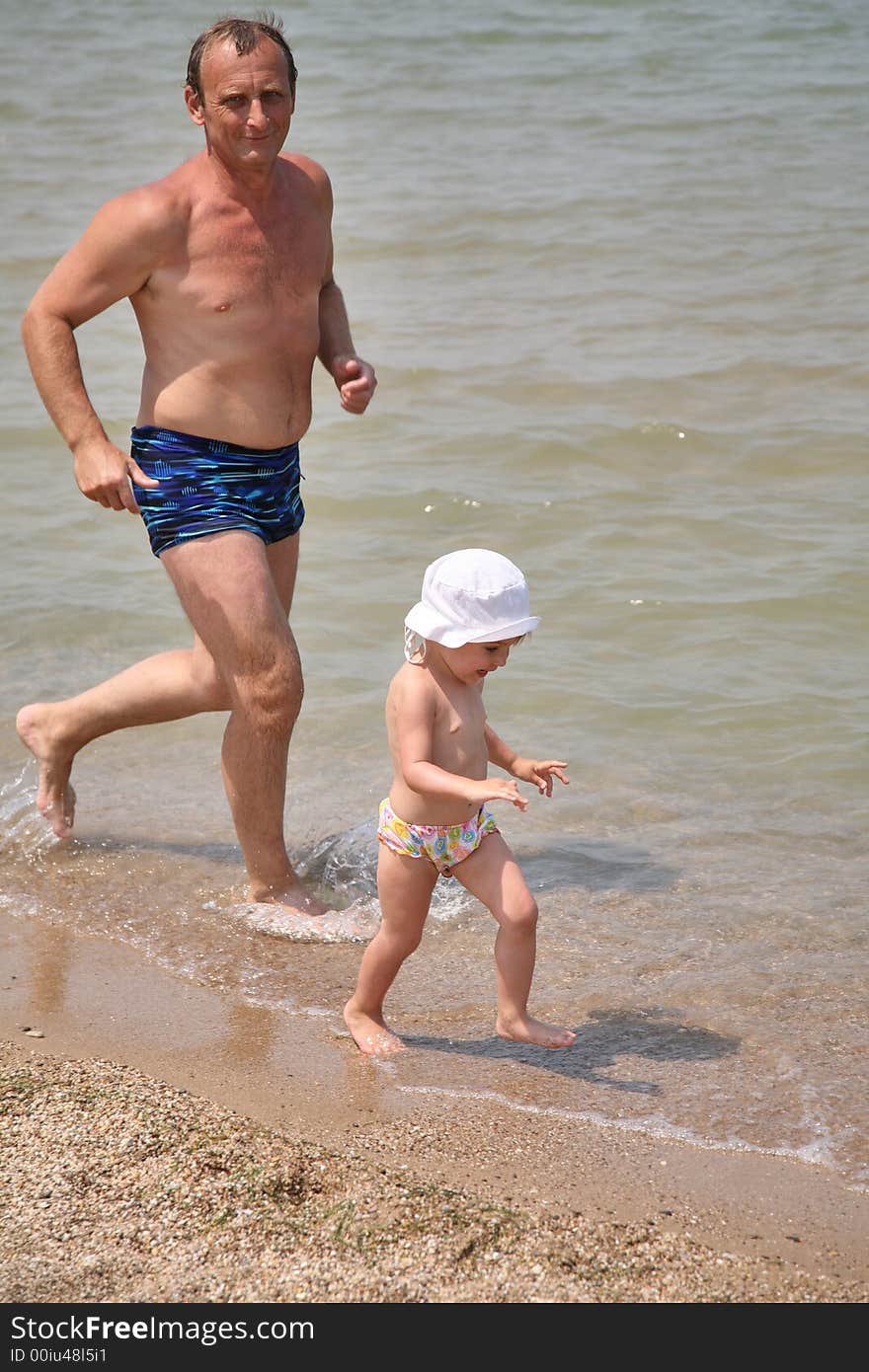 Grandfather with granddaughter run as to beach. Grandfather with granddaughter run as to beach