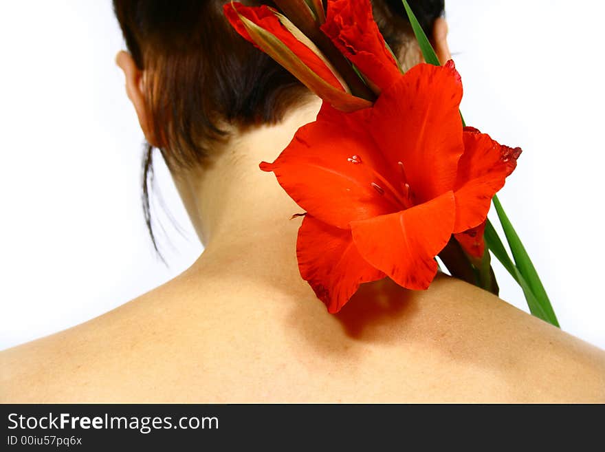 Back of a young woman with a flower and black hair. Back of a young woman with a flower and black hair