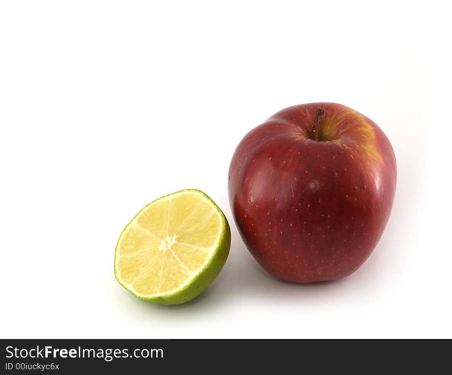 An apple variety called Red Cheaf and half of lime isolated on white. An apple variety called Red Cheaf and half of lime isolated on white.