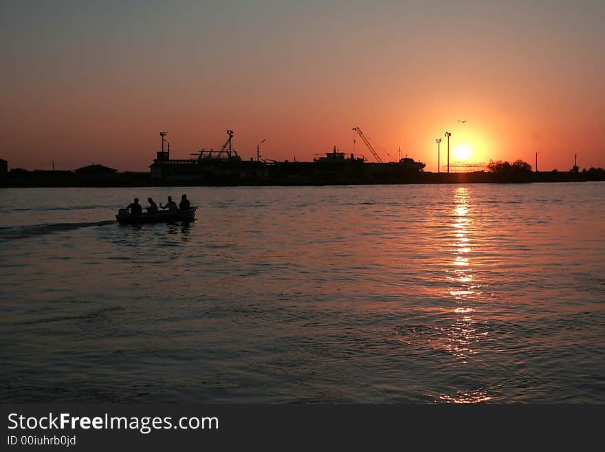 Sunrise on the Danube river, Sulina branch, with a building yard on the background. Sunrise on the Danube river, Sulina branch, with a building yard on the background