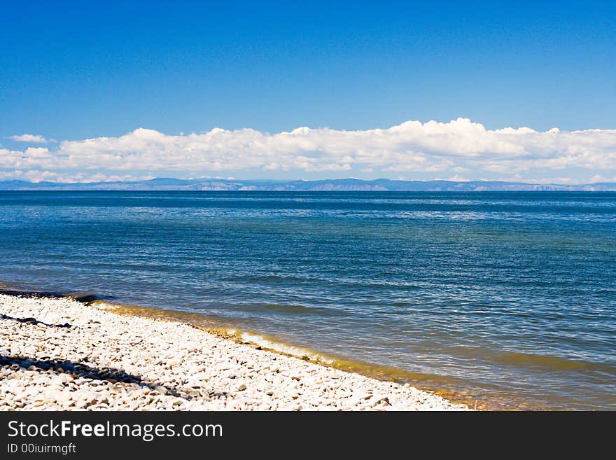 Baikal lakeside with mountains of Olhon island on skyline (lake Baikal - first-rate reservoir of unadulterated sweet water, it contains about 1/4 of all world's reserve)