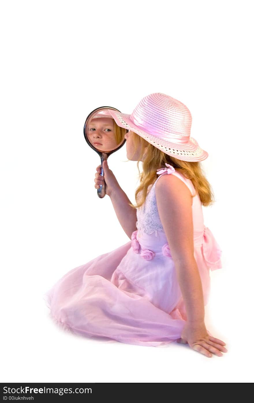 Young girl looking at herself in the mirror. Young girl looking at herself in the mirror