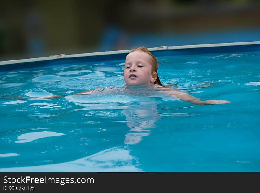 Young girl swims in the water