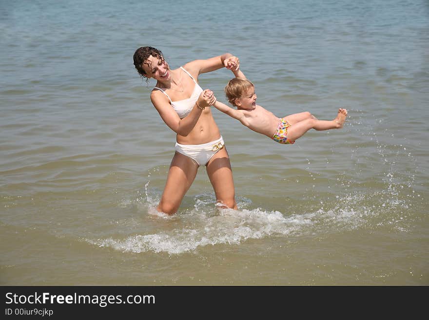 Mum and daughter have a good time in the sea. Mum and daughter have a good time in the sea