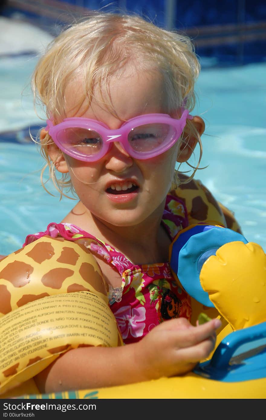 A kid in goggles in the pool