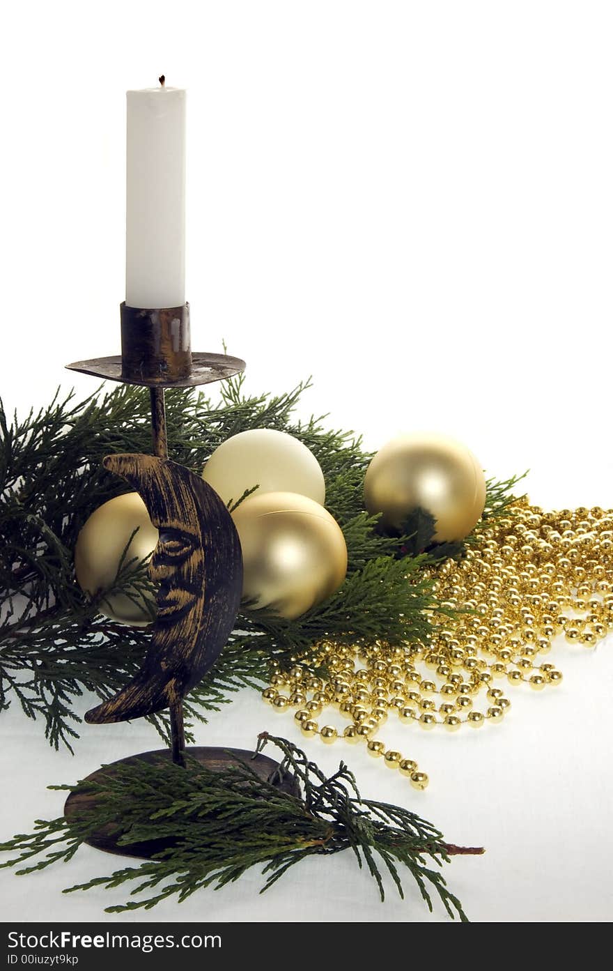 Complimentary golden & cream coloured christmas decorations with evergreen leaves and a candle stick with a new moon logo. Complimentary golden & cream coloured christmas decorations with evergreen leaves and a candle stick with a new moon logo