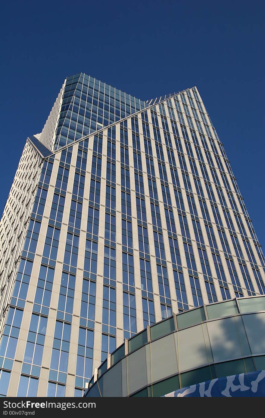 A modern glass office tower rising into the sky. A modern glass office tower rising into the sky