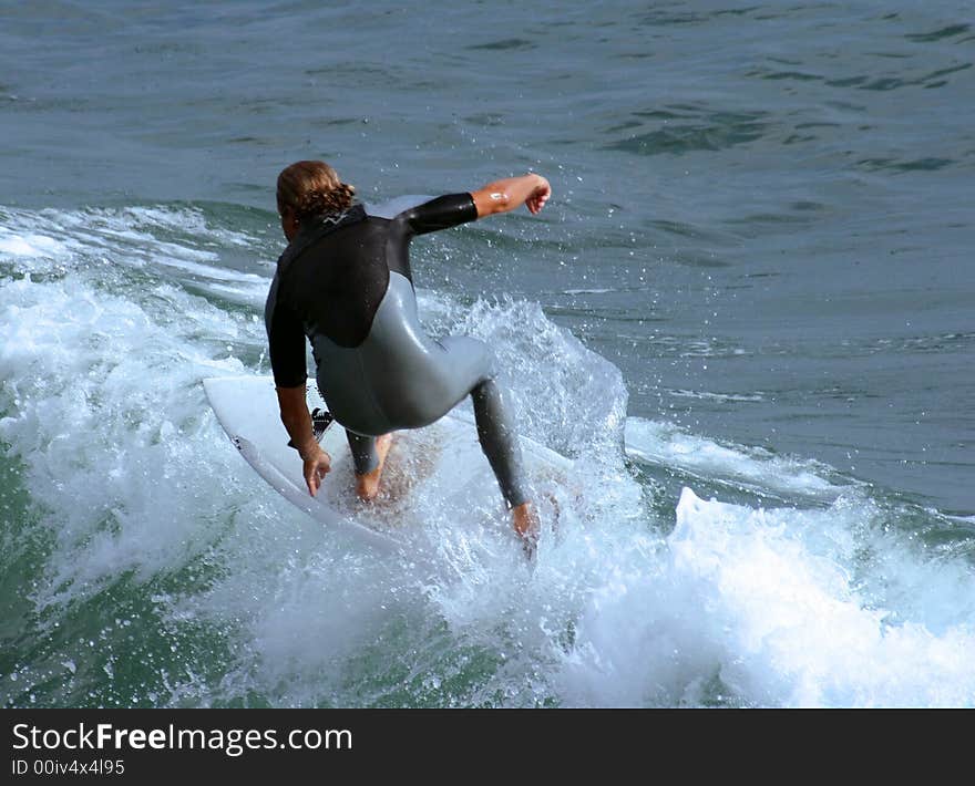 Close up of a male surfer catching a wave.