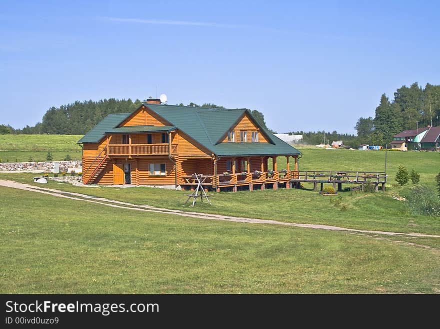 House in grassy foreground with flowers