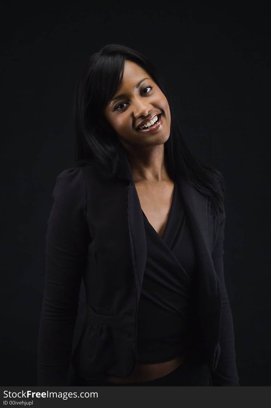 Three quarter pose of an African American woman smiling and tilting her head. Three quarter pose of an African American woman smiling and tilting her head.