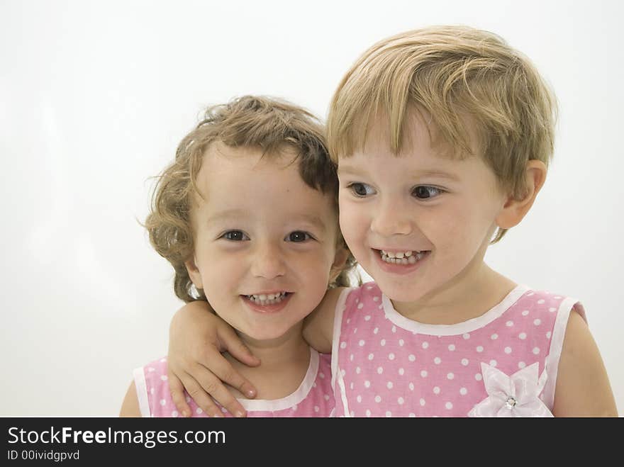 Twins sisters smiling and posing in the studio