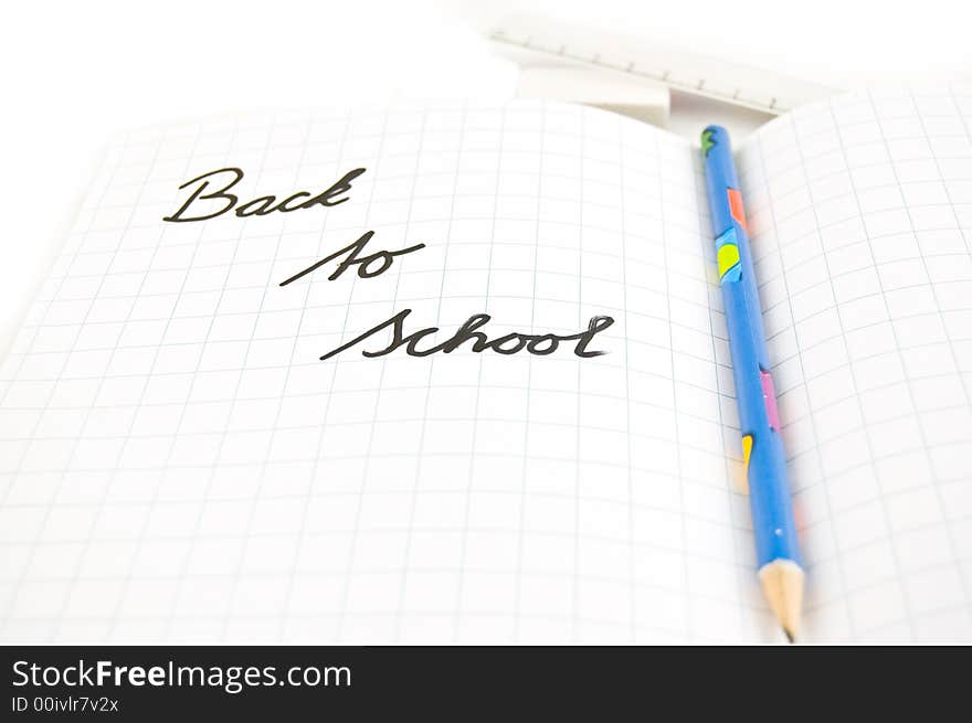 Back to school written in a schoolbook. Back to school written in a schoolbook