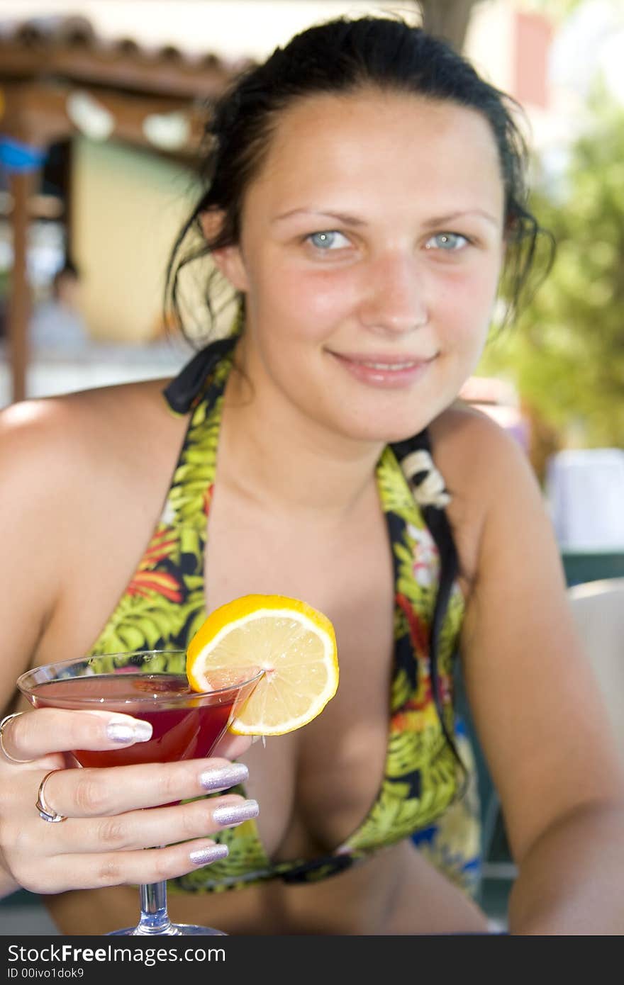 Young beautiful smiling woman with a cocktail. Young beautiful smiling woman with a cocktail