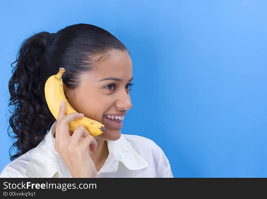 Beautiful girl holding banana close her ear. Beautiful girl holding banana close her ear