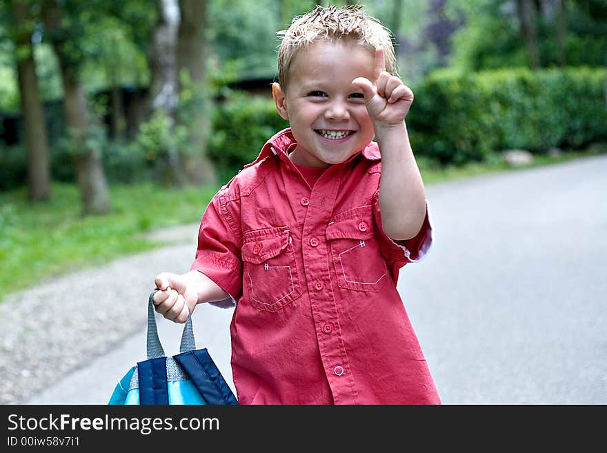 Kid Making A Little Sign