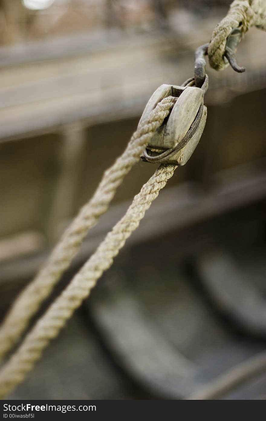 An old ship pulley system with inner hull of boat in background