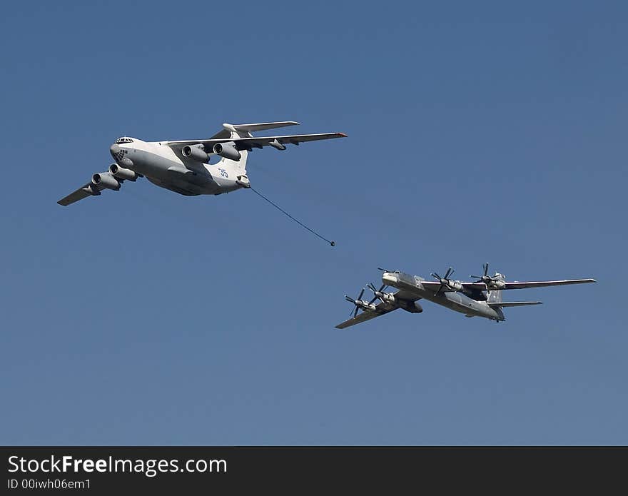 The distant Russian bomber refuels in air. The distant Russian bomber refuels in air