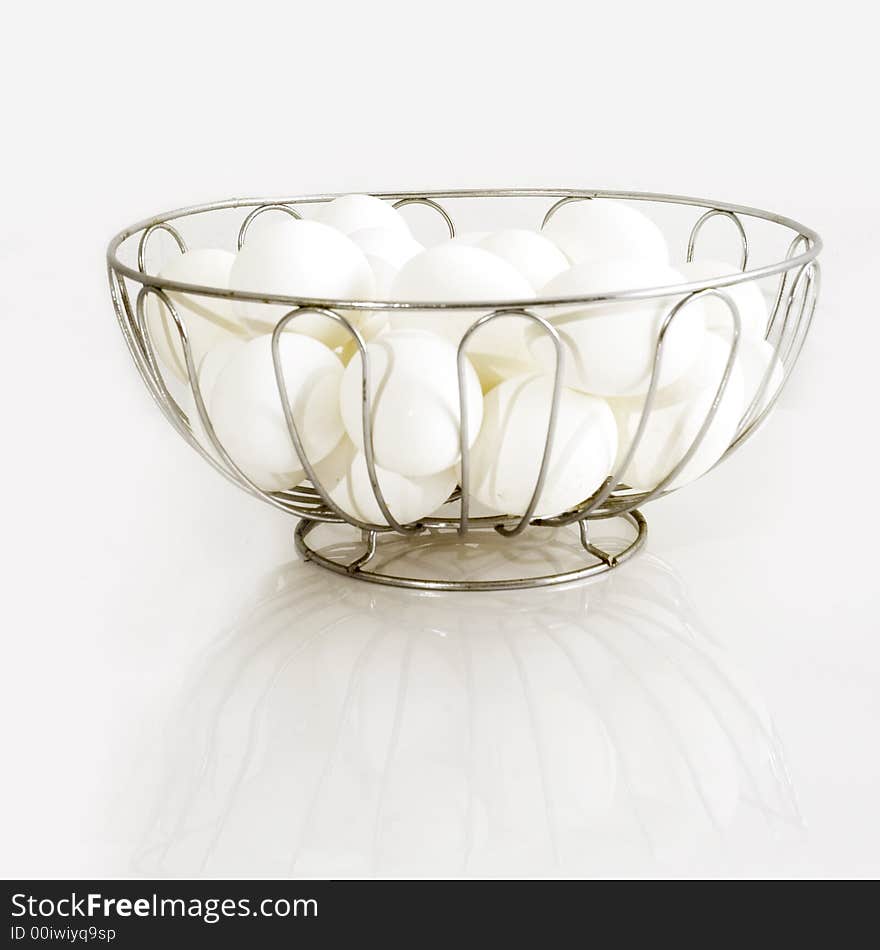 Basket of eggs over white background