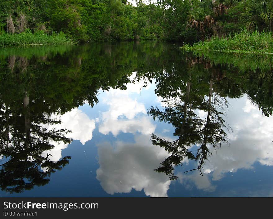 Not a ripple in sight, sky reflects beautifully on the water. Not a ripple in sight, sky reflects beautifully on the water