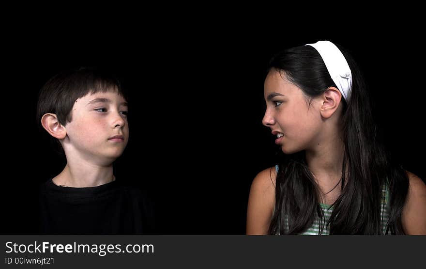 Brother and sister arguing over black background